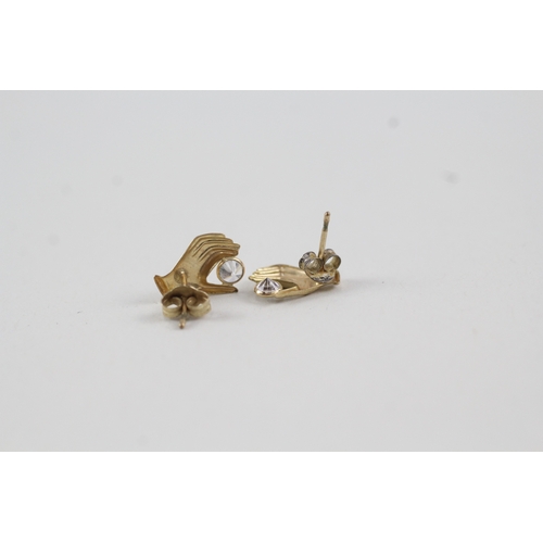 226 - 9ct gold and white gemstone hand stud earrings (0.6g)