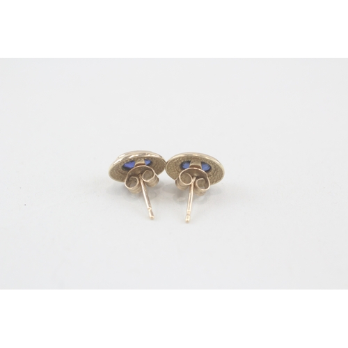 231 - 9ct gold blue gemstone stud earrings with scroll backs (1.6g)