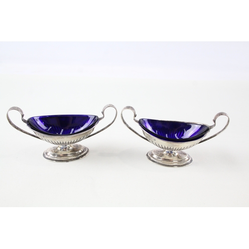 75 - 2 x .925 sterling silver twin handled condiment dishes w/ blue glass dishes