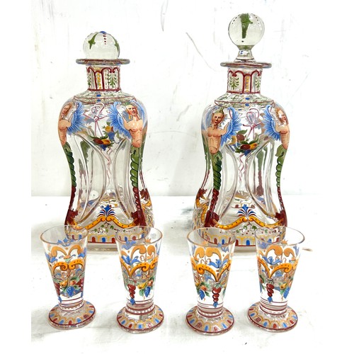 109 - Pair antique hand painted squeezed glass decanters with 4 cordials, height of decanter 10.5 inches