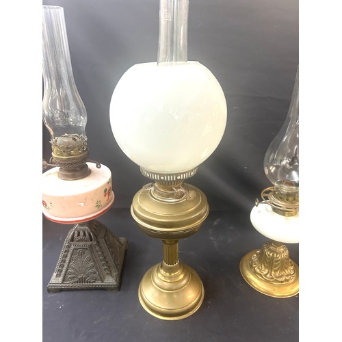 478 - 3 Vintage oil lamps, all with funnels one with shade