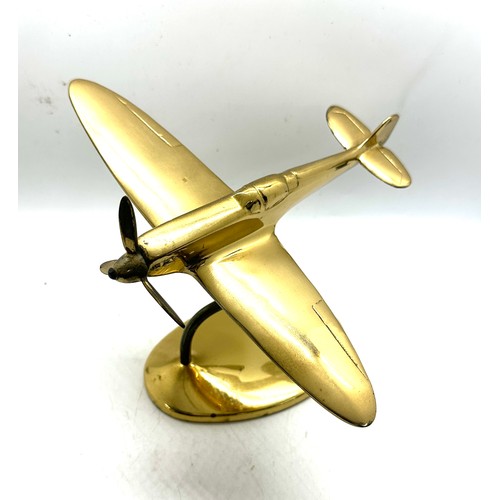 14 - A brass cast model of a Spitfire complete with stand measures approx 5 inches tall by 8 wide