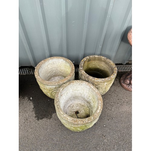 100H - Set of three concrete planters measures approximately 13 inches tall 15 inches diameter