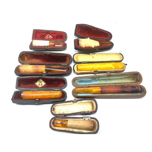 471 - selection of cased antique amber etc Cheroot  Holders