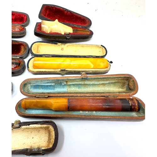 471 - selection of cased antique amber etc Cheroot  Holders