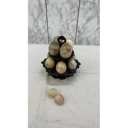 28 - Selection of onyx eggs on cast iron stand