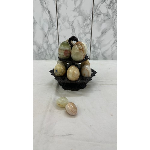 28 - Selection of onyx eggs on cast iron stand