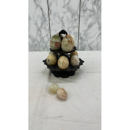 28 - Selection of onyx eggs on cast iron stand