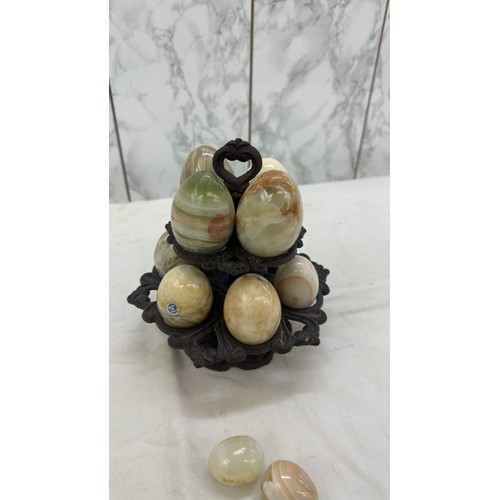 28 - Selection of onyx eggs on cast iron stand