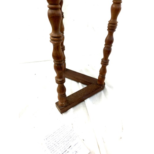 378 - Three legged table measures approximately 25 inches tall by 13.5 inches