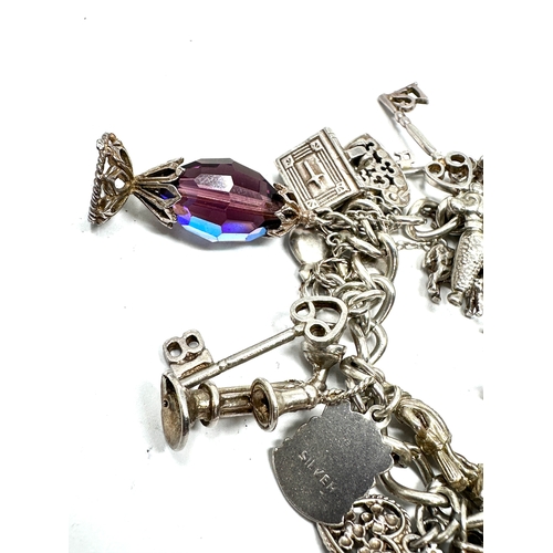 265 - Heavy vintage silver charm bracelet and charms with opening charms weight 92g