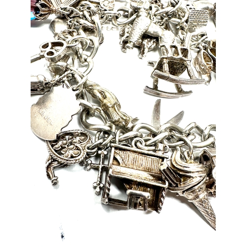 265 - Heavy vintage silver charm bracelet and charms with opening charms weight 92g