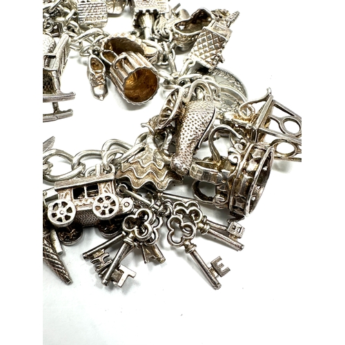 265 - Heavy vintage silver charm bracelet and charms with opening charms weight 92g