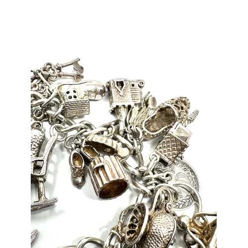 265 - Heavy vintage silver charm bracelet and charms with opening charms weight 92g