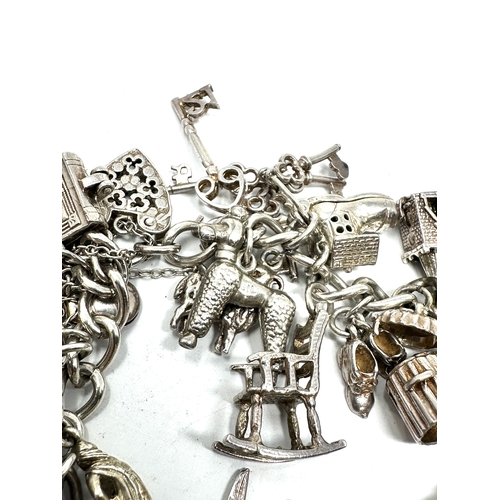 265 - Heavy vintage silver charm bracelet and charms with opening charms weight 92g