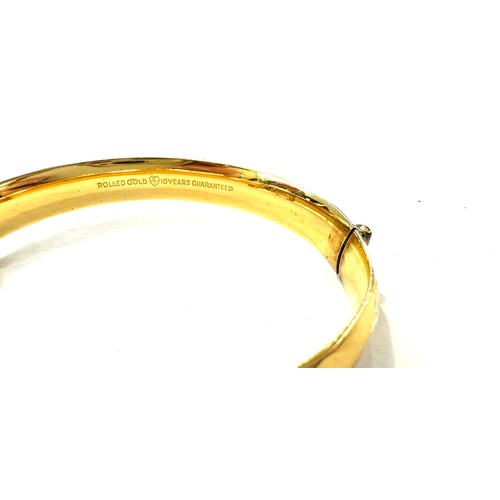 510 - Rolled gold bangle with 10 year guarantee, total approximate weight 31.1g