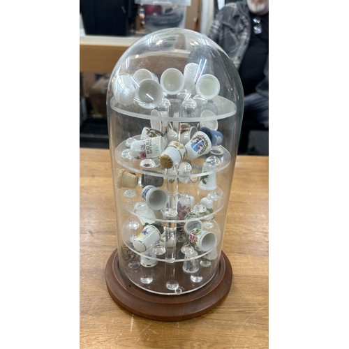 9 - Vintage glass dome with a selection of assorted thimbles