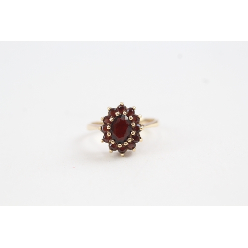 97 - 9ct gold garnet set cluster ring (2.7g)