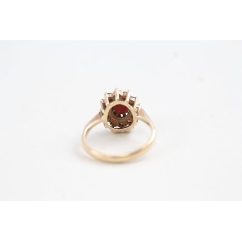 97 - 9ct gold garnet set cluster ring (2.7g)