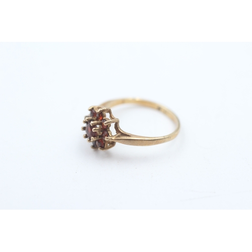 115 - 9ct gold garnet halo ring (1.3g)