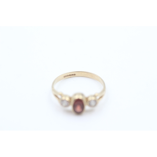 152 - 9ct gold garnet and white gemstone trilogy ring (1.5g)