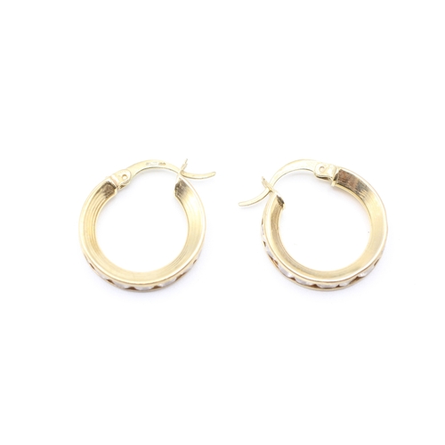 164 - 9ct gold cubic zirconia channel set hoop earrings (3.1g)