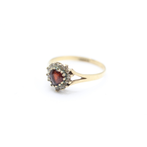 221 - 9ct gold heart cut garnet and cubic zirconia halo dress ring (1.6g)