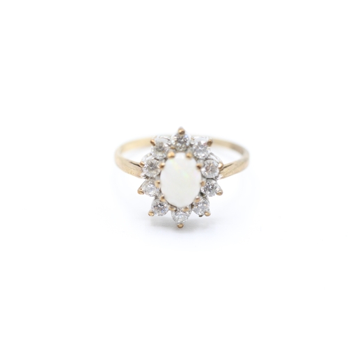 223 - 9ct gold opal and cubic zirconia halo dress ring (2.2g)