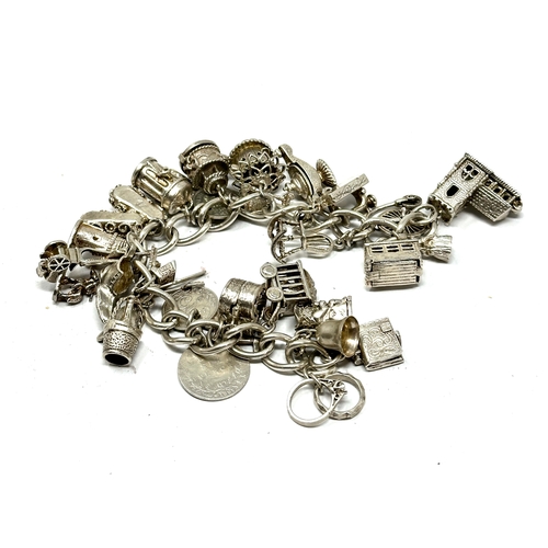 273 - Heavy vintage silver charm bracelet incluses opening charms etc weight 118g