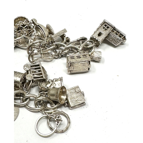 273 - Heavy vintage silver charm bracelet incluses opening charms etc weight 118g