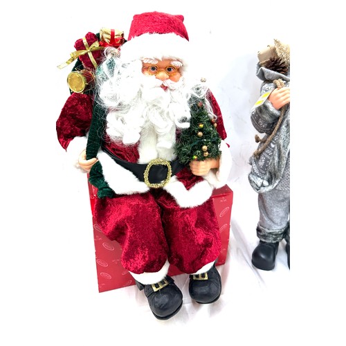 322 - Freestanding Santa decoration, a sitting Santa decoration, tallest measures approximately24 inches