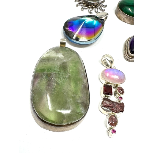 291 - 8 silver stone set pendants weight 125g