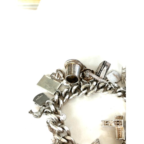 558 - Chunky ladies silver charm bracelet with various charms overall weight 135g