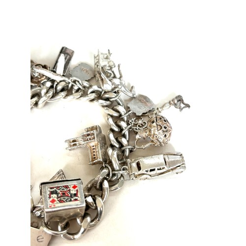 558 - Chunky ladies silver charm bracelet with various charms overall weight 135g