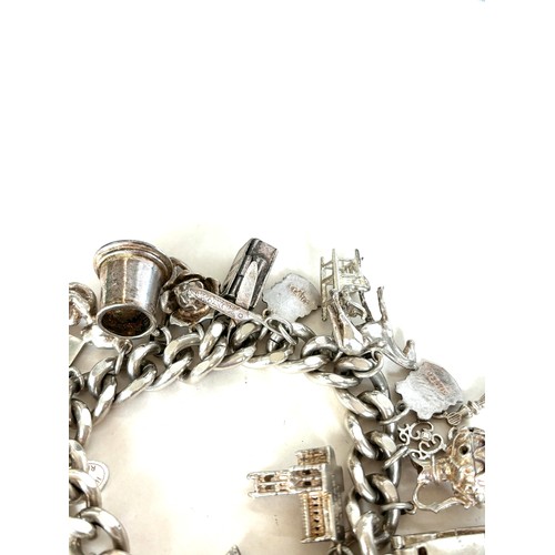 558 - Chunky ladies silver charm bracelet with various charms overall weight 135g