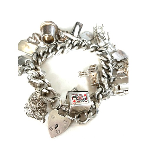 558 - Chunky ladies silver charm bracelet with various charms overall weight 135g