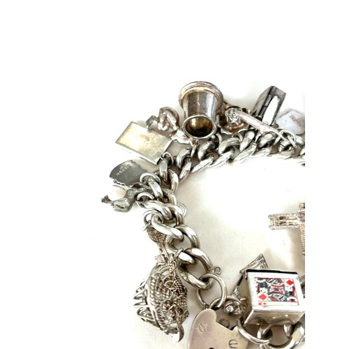 558 - Chunky ladies silver charm bracelet with various charms overall weight 135g