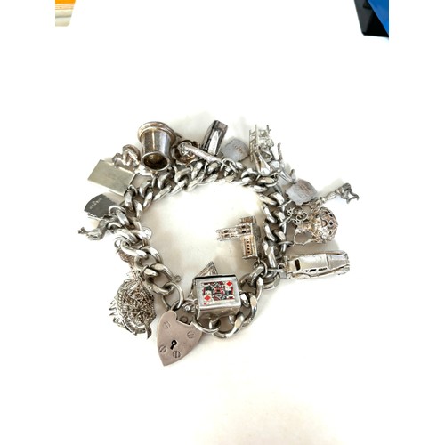 558 - Chunky ladies silver charm bracelet with various charms overall weight 135g