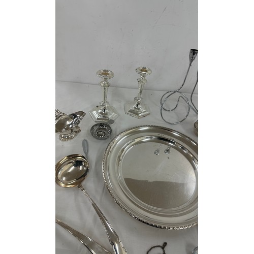 104 - Selection of silver plate items to include candle sticks, pen, trays etc