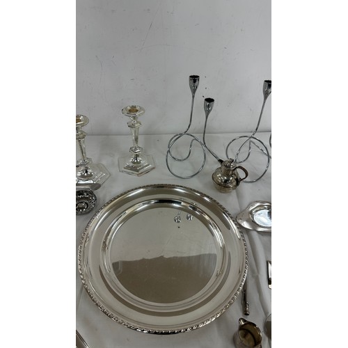 104 - Selection of silver plate items to include candle sticks, pen, trays etc