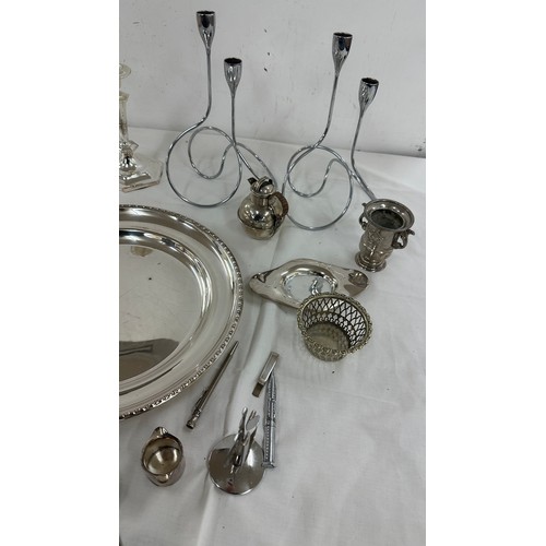 104 - Selection of silver plate items to include candle sticks, pen, trays etc