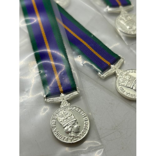 599 - Dealers lot of 25 miniature accumulated campaign service medals manufactured by Toye, Kenning and Sp... 