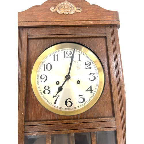 9 - 2 Keyhole wooden wall clock with key and pendulum, approximate measurements: Length 31 inches, Width... 