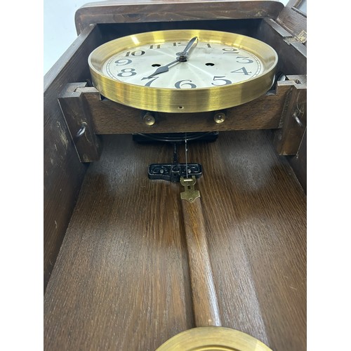 9 - 2 Keyhole wooden wall clock with key and pendulum, approximate measurements: Length 31 inches, Width... 