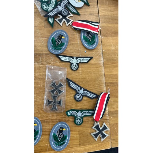 90 - Reproduction WW1 and WW2 German Iron crosses and an Insignia and WW1 memorial scroll