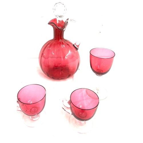 26 - 7 pieces of Cranberry glass to include a decanter, vase, salt and pepper pots, cups etc