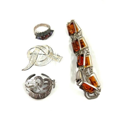 586 - Selection of silver jewellery includes amber bracelet, brooches, ring etc