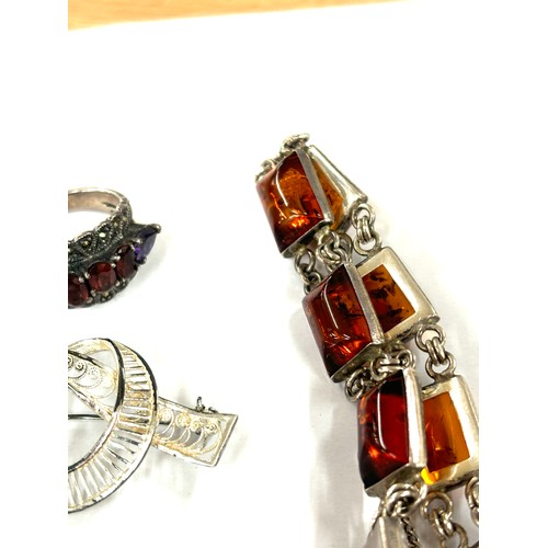 586 - Selection of silver jewellery includes amber bracelet, brooches, ring etc