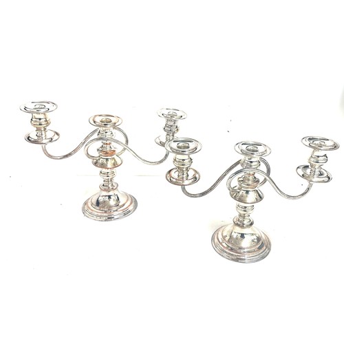 555A - Two silver plated  and copper candelabras measures approximately 9.5 inches tall by 12 wide