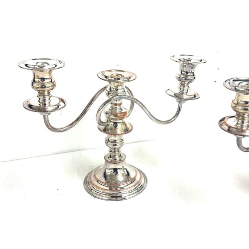 555A - Two silver plated  and copper candelabras measures approximately 9.5 inches tall by 12 wide